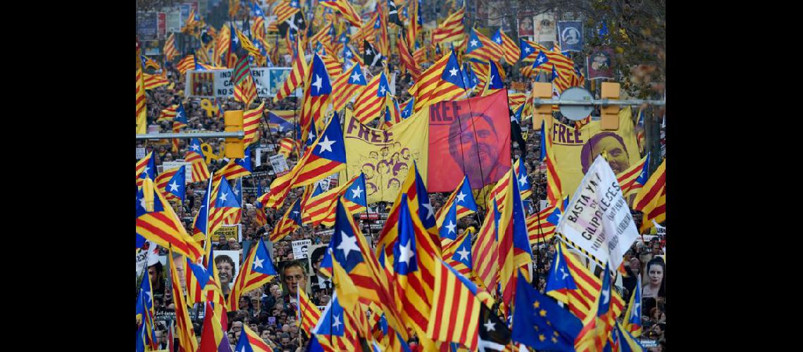  Los manifestantes sostienen retratos de los separatistas catalanes encarcelados y ondean banderas a favor de la independencia (NA)